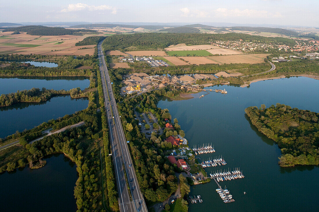 Aerial shot of Autobahn A7 and shingle ponds near Northeim, Lower Saxony, Germany