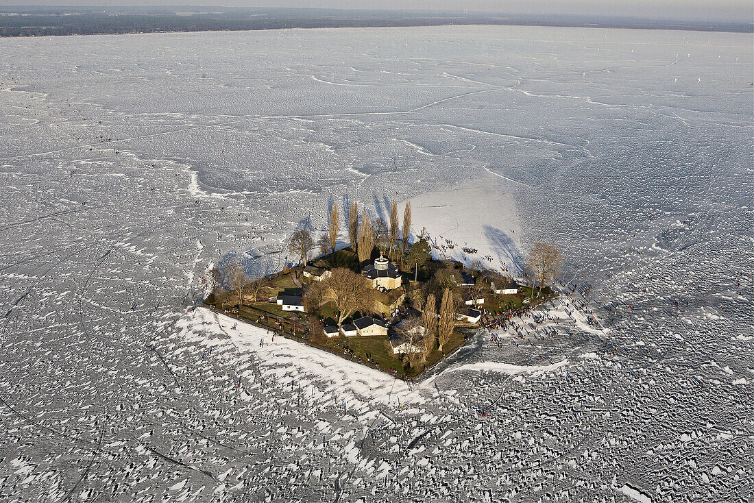 Aerial of people on the frozen Lake Steinhude in winter, Wilhelmstein island, Hannover region, Lower Saxony, Germany