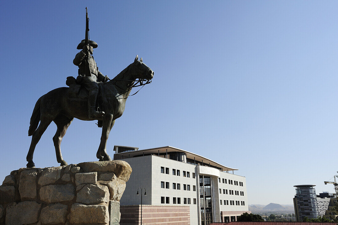 Equestrian memorial of Rider of Southwest looking towards modern buildings, Suedwester Reiter, Old fort, Windhuk, Windhoek, Namibia