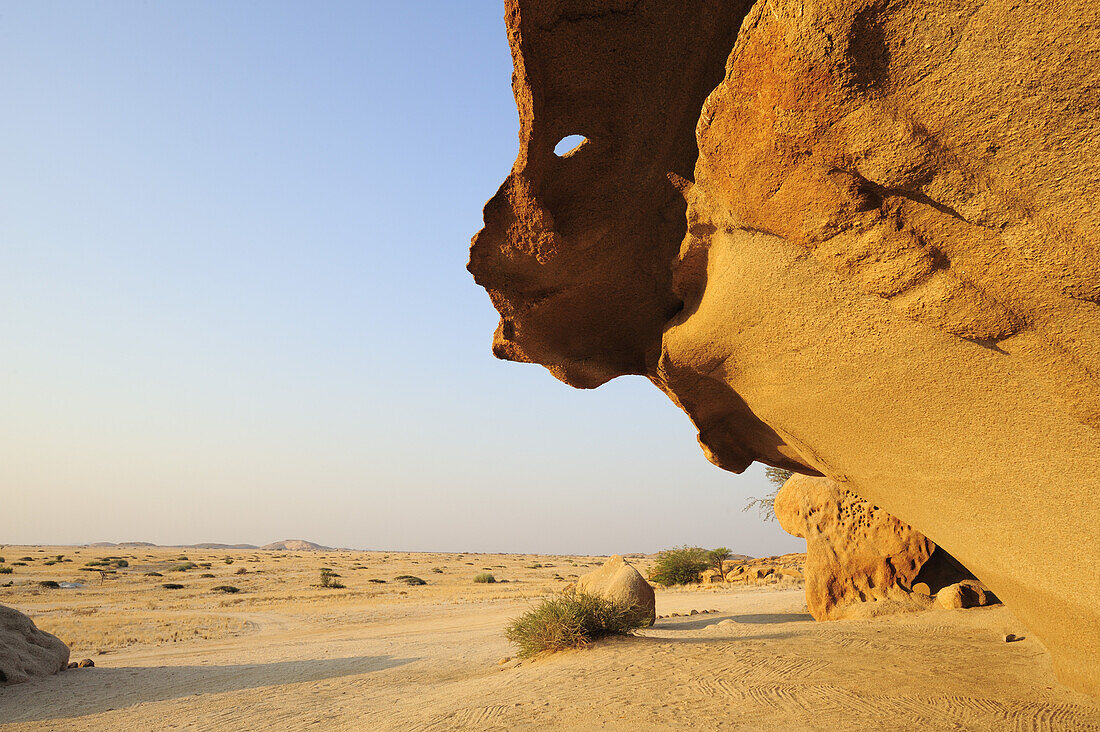 Rock overhang with view to savannah, Namib desert, Namib, Namibia