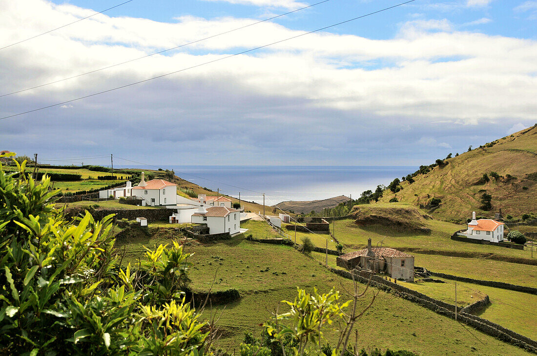 Houses at the south coast under clouded sky, Island of Santa Maria, Azores, Portugal, Europe