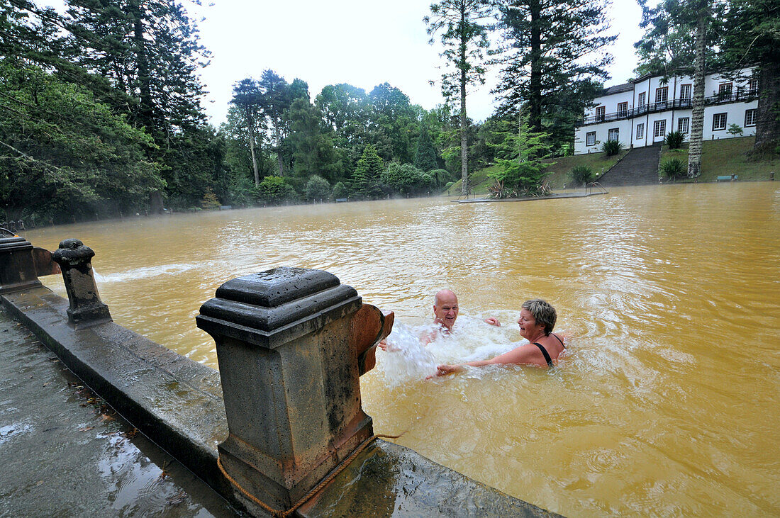 People bathing in a lake, Parque Terra Nostra at thermal area at Furnas, east part of the Island of Sao Miguel, Azores, Portugal, Europe