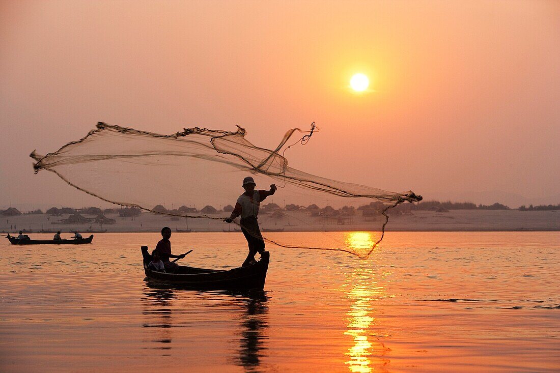 Fisherman Fishing with net at sunset, Mandalay, Myanmar.