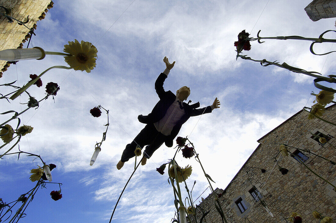 Mannequin flying over flowers. Girona Flower Festival. Girona. Catalonia. Spain