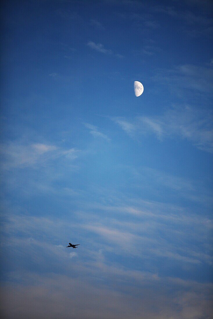 Flying plane and moon