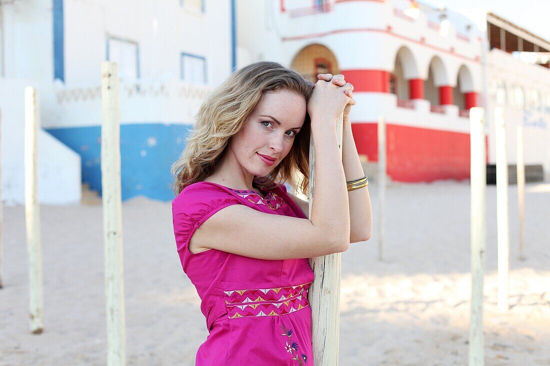 Woman poses in Carvoeiro beach, Algarve, Portugal