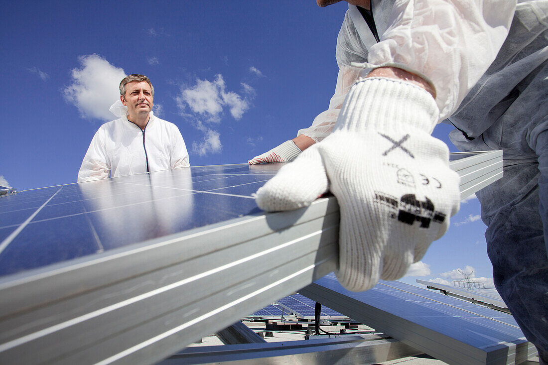 Technicians installing a photovoltaic power plant, Hamburg, Germany