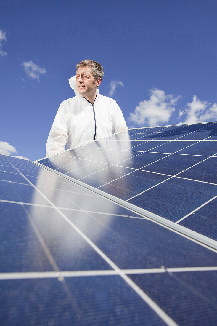 Technician installing a photovoltaic power plant, Hamburg, Germany