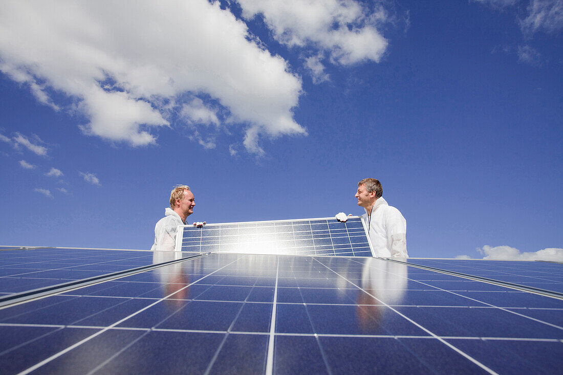 Technicians installing a photovoltaic power plant, Hamburg, Germany