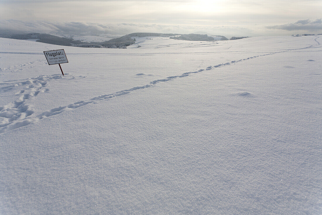 to leave one's mark in the snow, snowy landscape, signboard, signpost, airfield, airport, scenery, near Gersfeld, Wasserkuppe, low mountain range, Rhoen, Hesse, Germany