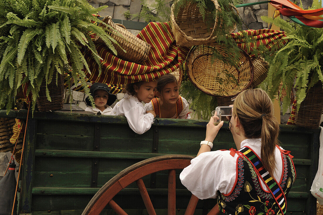 Decorated oxcart with children and woman in traditional costume, Los Realejos, Romeria, Tenerife, Canary Islands, Spain