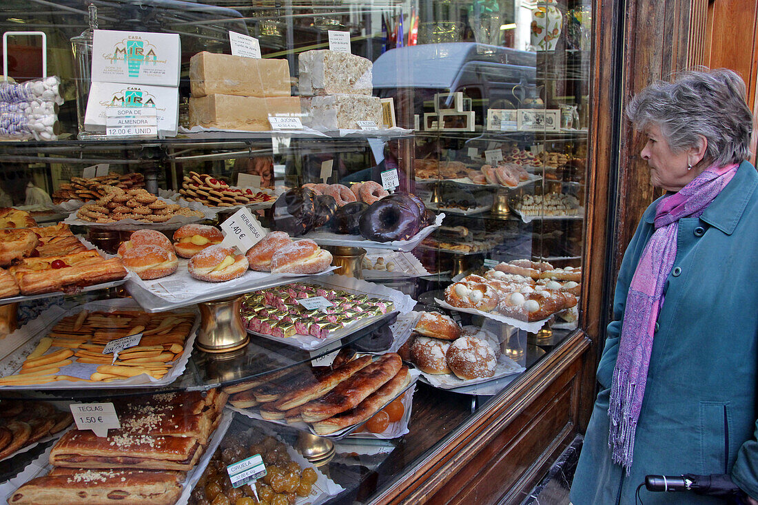 Person In Front Of The Cakes In A Pastry Shop, Madrid, Spain