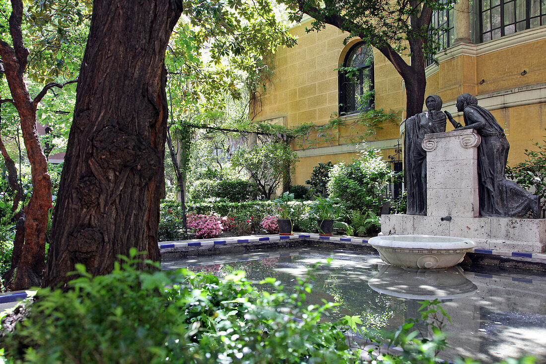 Statue Of Women In Front Of The Fountain In The Gardens Of The Museum Home Of The Painter Joaquin Sorolla, Madrid, Spain