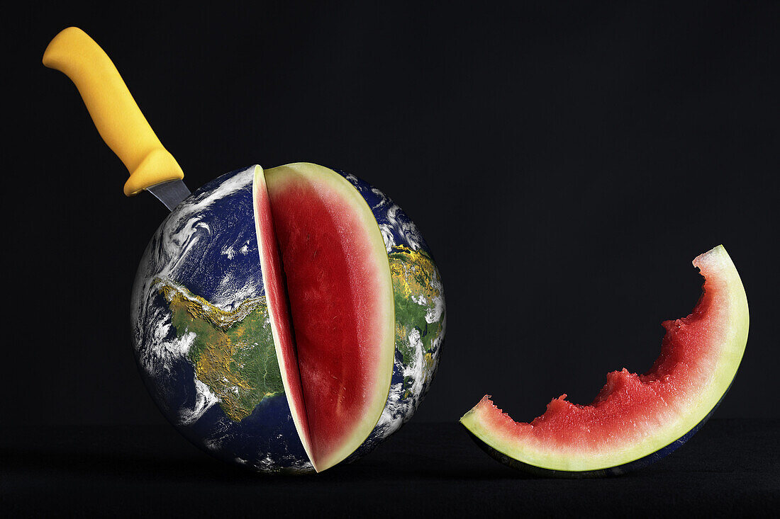 Knife Stuck Into A Watermelon In The Form Of The Earth With A Slice Bitten Out Of It, Illustration Of The Consumption Of The Planet's Natural Resources, Photo Exhibition 'Fragile Earth' Presented By The Association 'L'Effet Colibri' France
