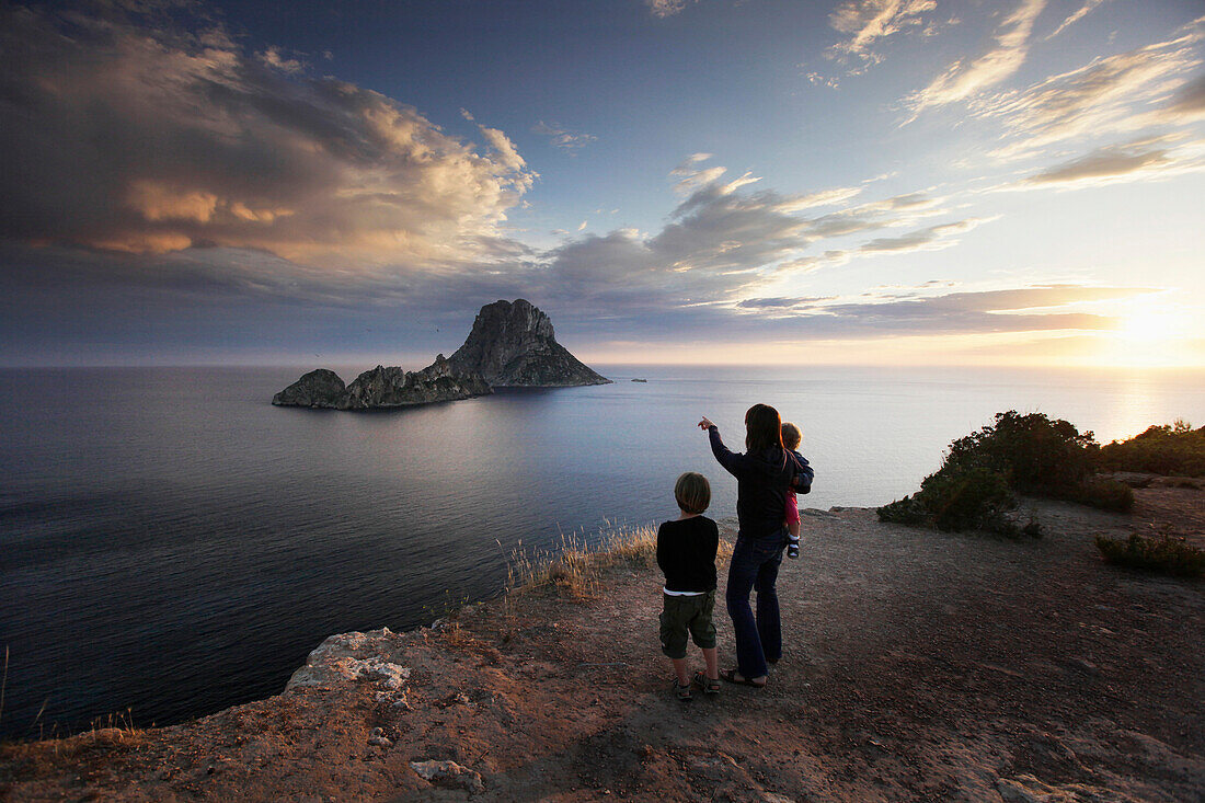 Mother and children enjoying view to Es Vedra and Es Vedranell, Ibiza, Balearic Islands, Spain