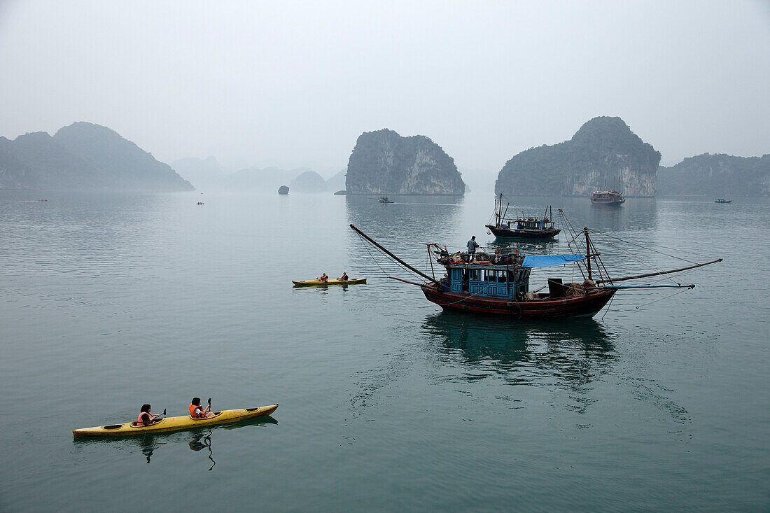 Kayak and fishing boat, Halong Bay, Quang Ninh, Vietnam