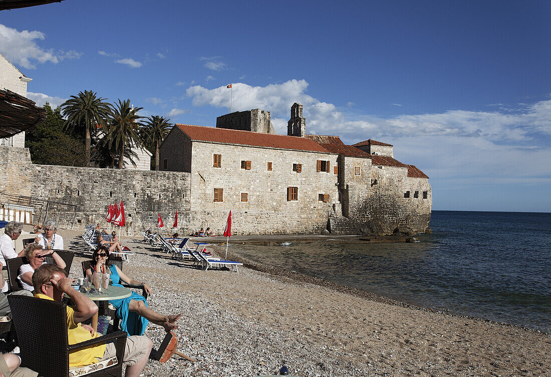 People sitting in a cafe on the city beach, Budva, Montenegro, Europe