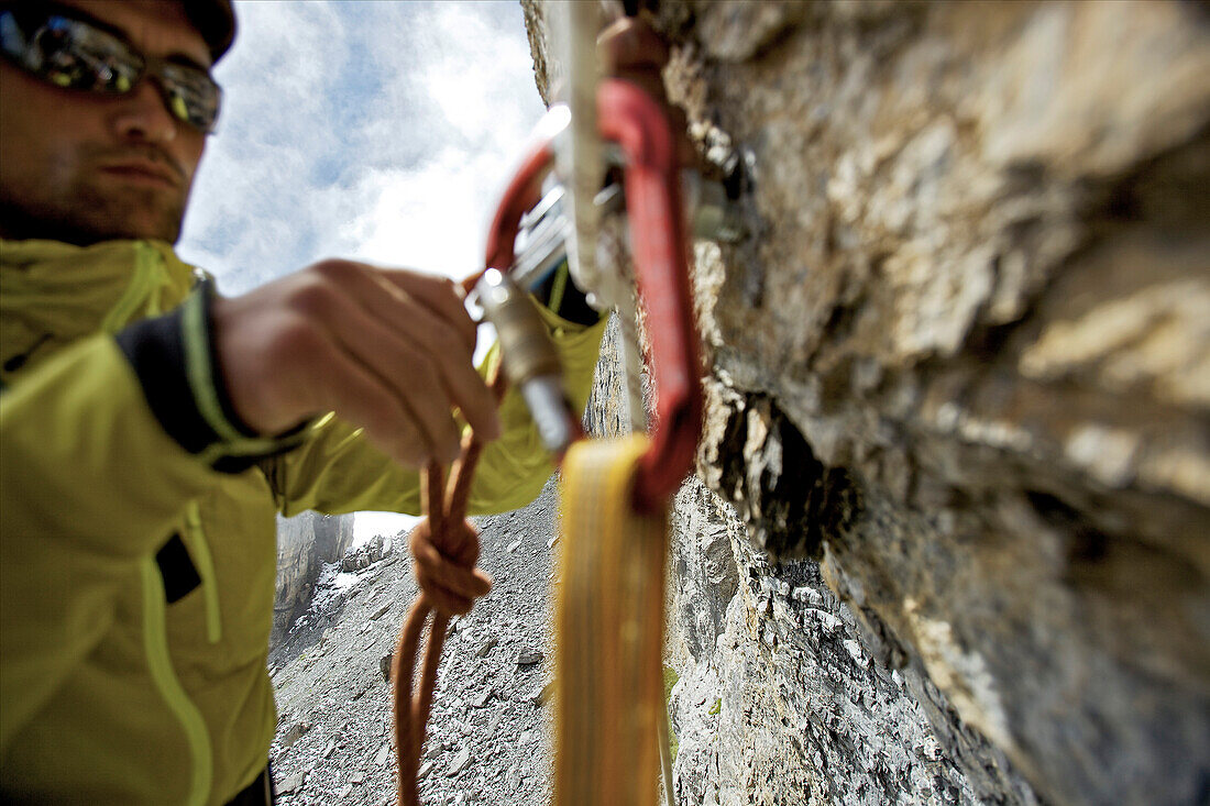 Climber fitting a carabiner, Schilthorn, Bernese Oberland, Canton of Bern, Switzerland