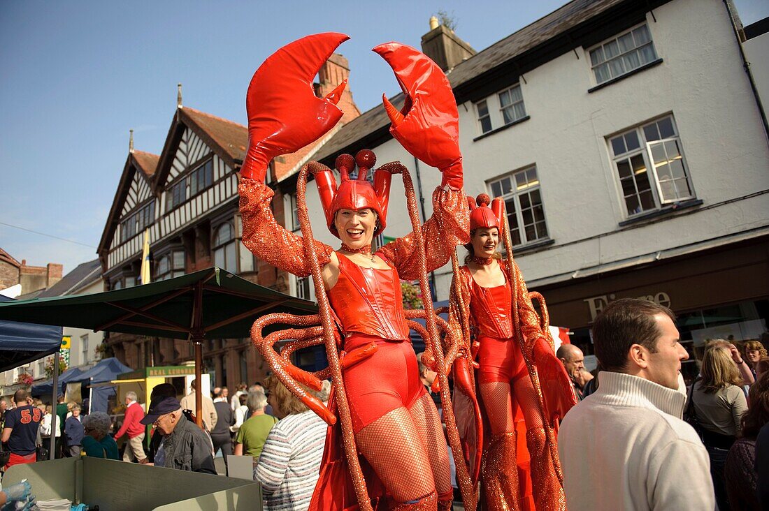 Two women stilt artists dressed as lobsters at the Abergavenny food festival, Monmouthshire south wales UK September 19 2009