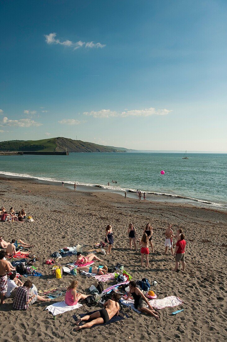 A group of students relaxing after their exams and playing on Aberystwyth beach, Cardigan Bay, West Wales, UK