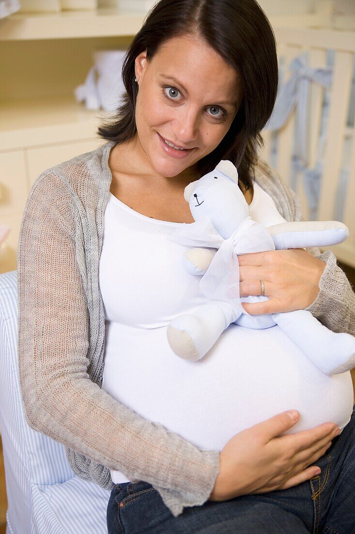 Pregnant women in the baby's room.