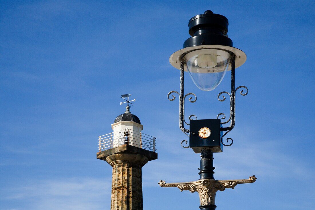 Ornate Lamp Standard and The West Pier Lighthouse at Whitby North Yorkshire England