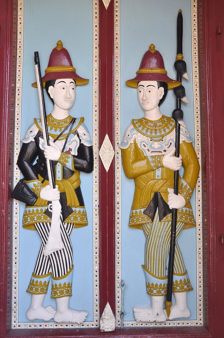 Bangkok (Thailand): ancient guards on a door's relief at the Royal Palace