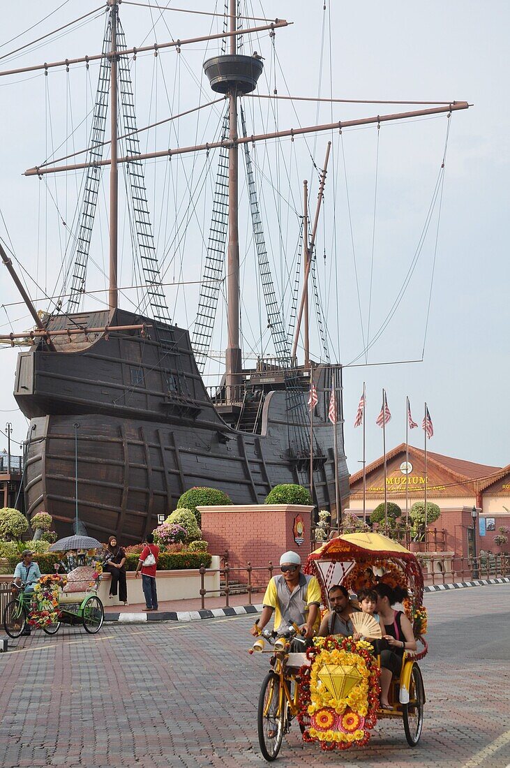 Malacca (Malaysia): a rickshaw by the replica of the sunken Portuguese ship Flor De La Mar, part of the Maritime Museum
