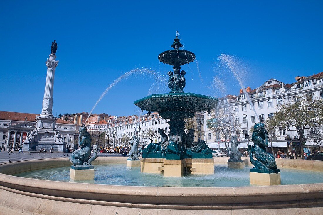 Fountain with sculptures and statue of King Dom Pedro IV in Rossio Square, also called Praca de Dom Pedro IV, in the old city, Lisbon, Portugal