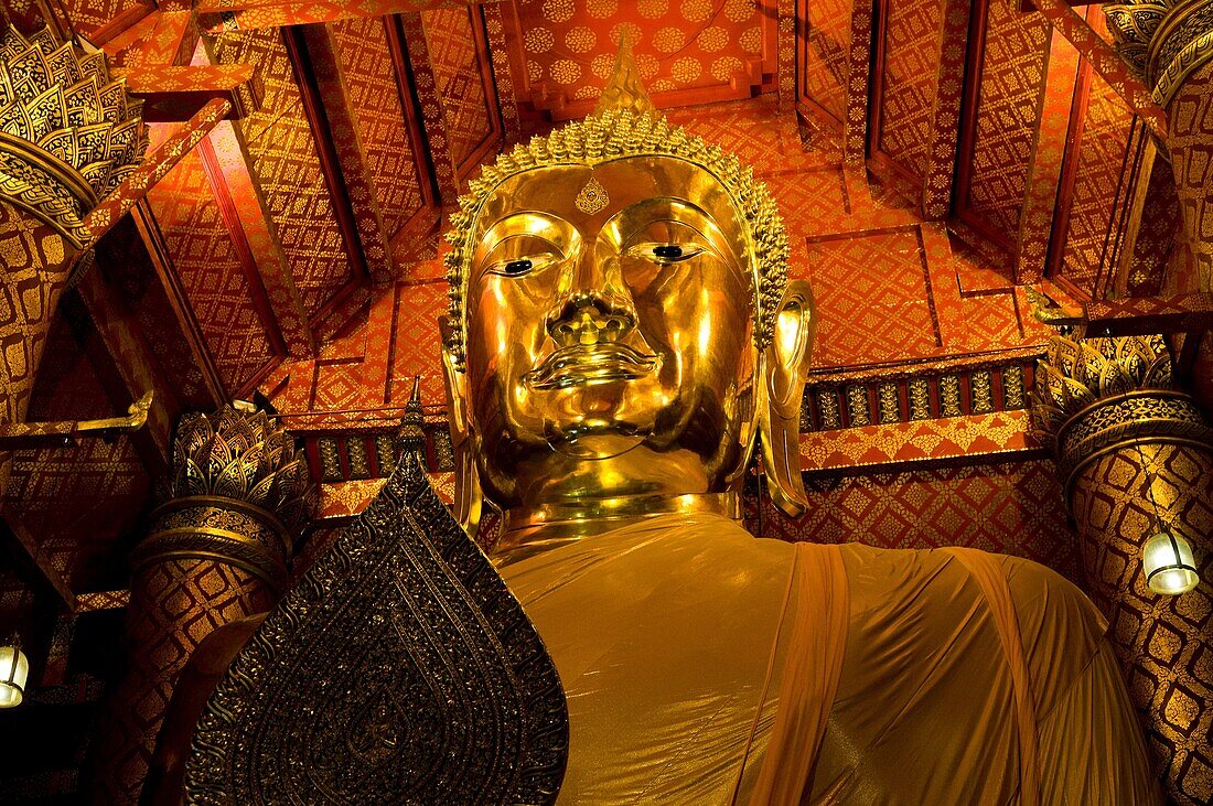 A golden Buddha in one of many old Buddhist temples in and around Ayutthaya, Thailand.
