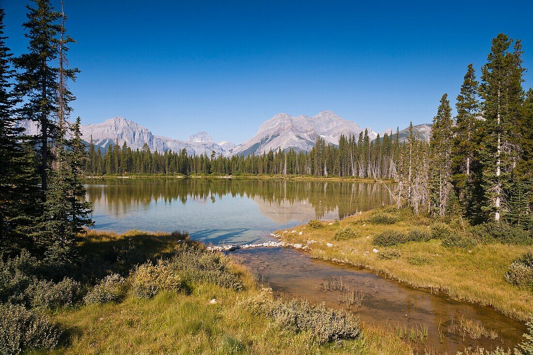 Mountain scenery and peaceful lake in Kananaskis Country, Alberta, Canada