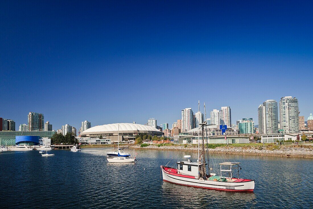 Ships in front of the BC Place Stadium and the skyline of Vancouver, British Columbia, Canada