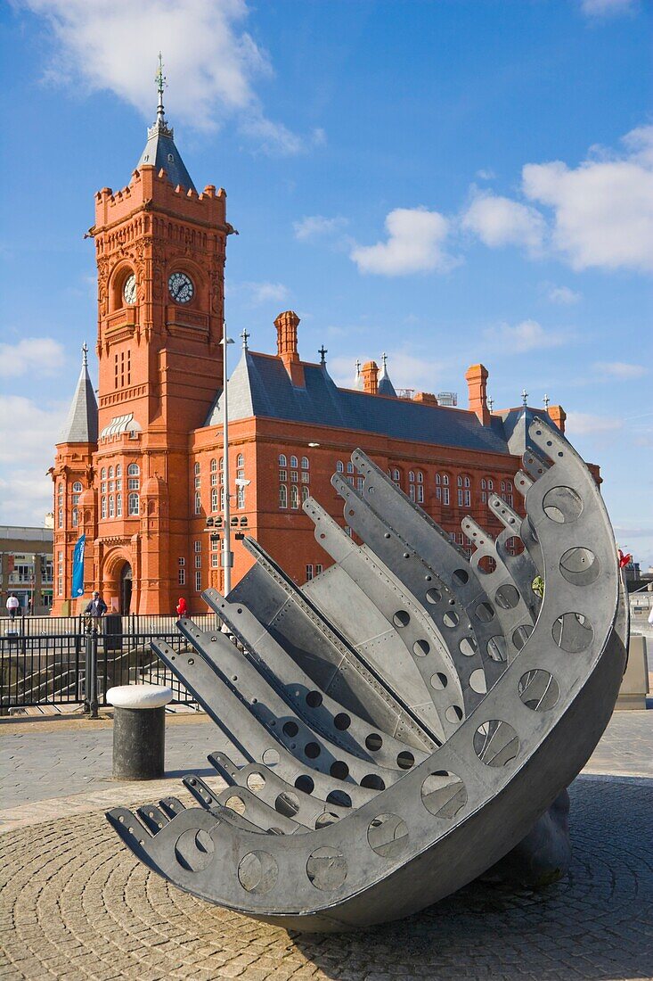 Merchant Seafarer's War Memorial by Brian Fell against The Pierhead Building by Welsh architect William Frame. Cardiff Bay. Cardiff. Caerdydd. Wales. South Glamorgan. UK.
