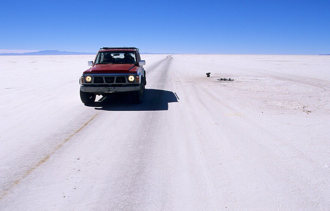 Driving car on the salt lake Salar de Uyuni, Altiplano, Bolivia, South America
