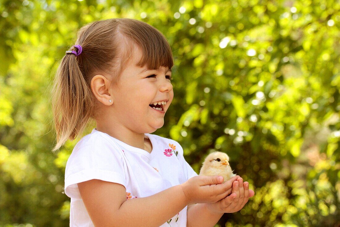Little girl with chick