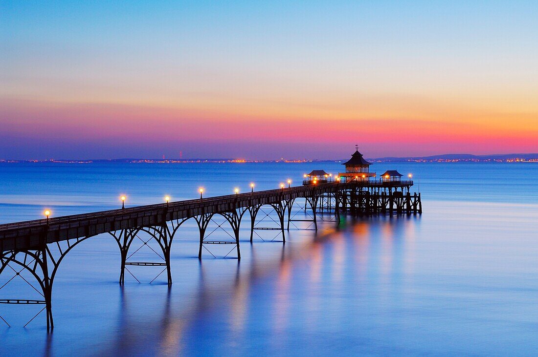 The pier in the Bristol Channel at the seaside town of Clevedon at dusk Somerset, England