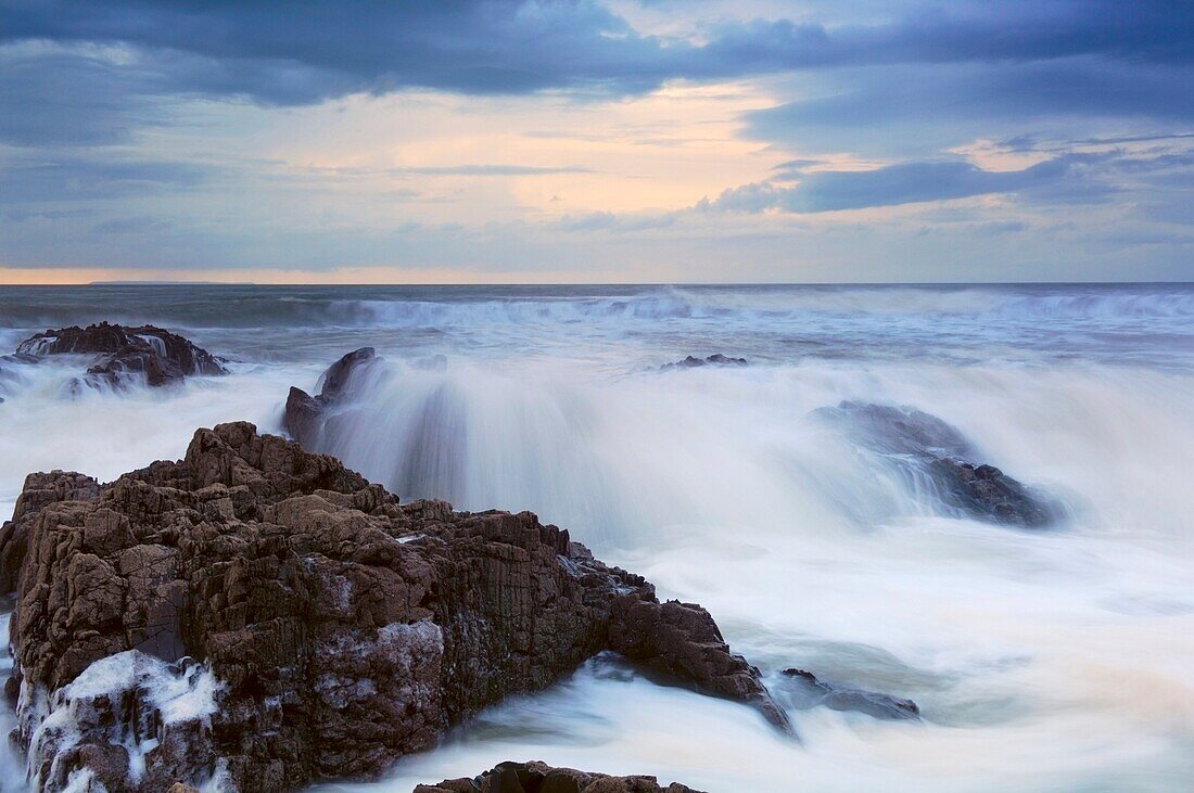 The incoming tide washing over the rocks at Westward Ho! in Devon, England