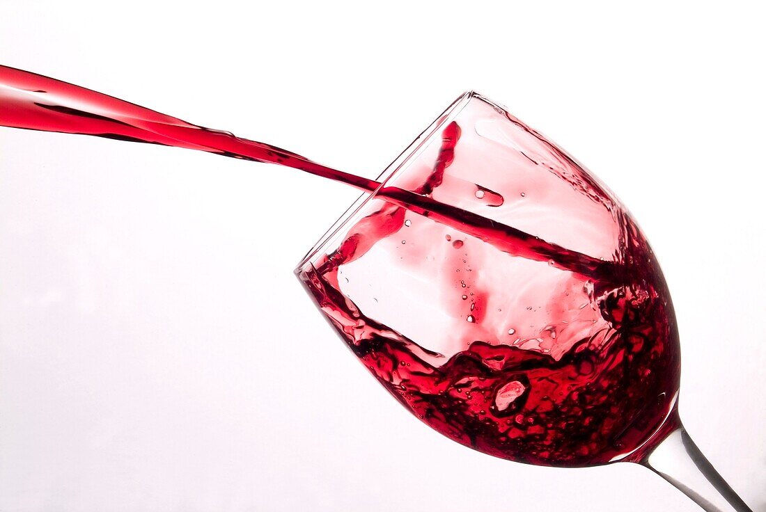 Red wine splashing into wine glass