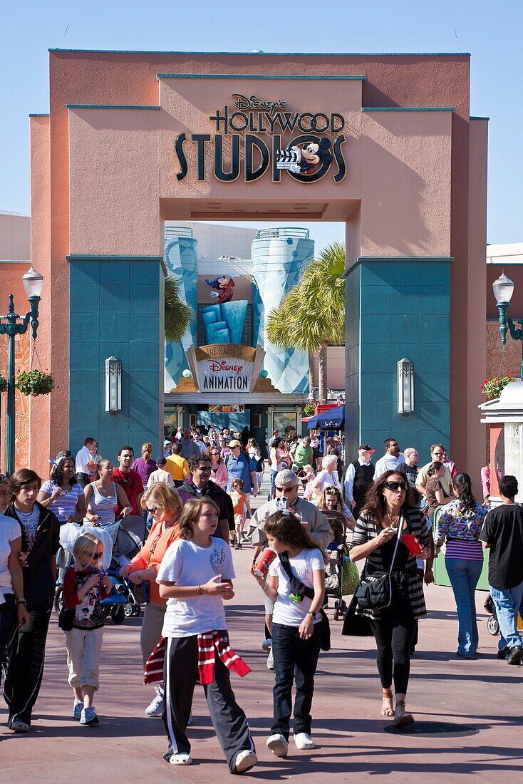 Orlando, FL - Feb 2009 - Park visitors walk under Disney's Hollywood Studios sign above walkway at Hollywood Studios theme park in Kissimmee Orlando Florida