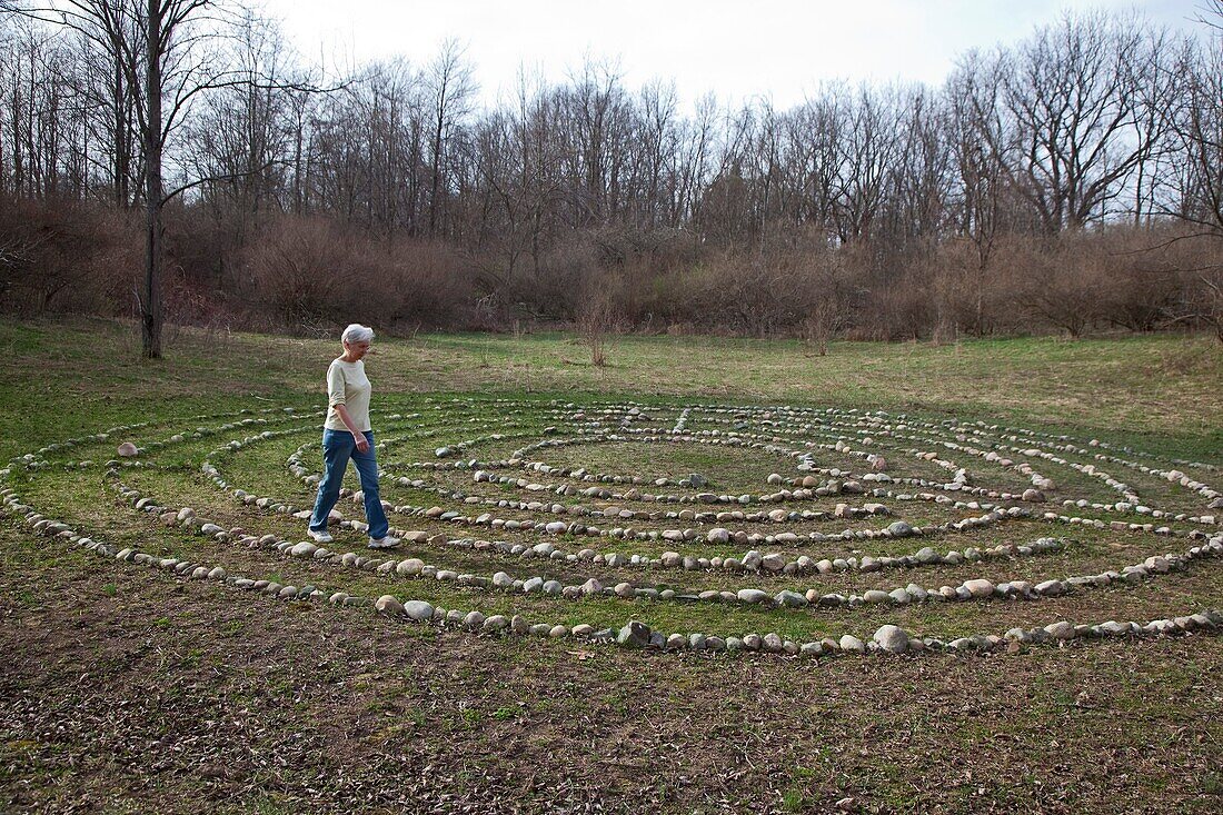 Prairieville, Michigan - A woman walks a labyrinth at Circle Pines camp The labyrinth is an aid to meditation the spiritualism © Jim West