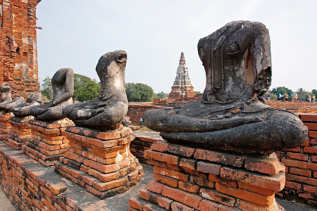 Row of headless Buddha figures in Wat Chai Wattanaram, ruined Buddhist temple in Ayutthaya, Thailand