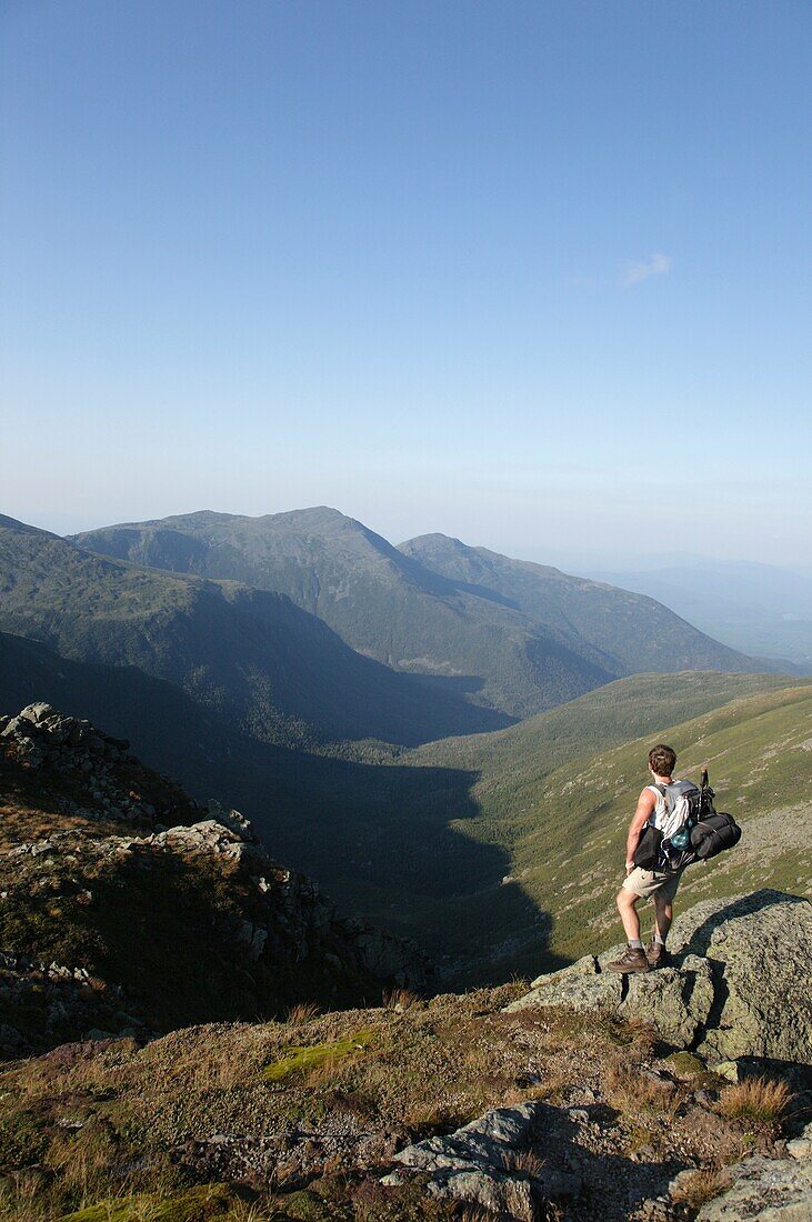 A hiker enjoys the view of Great Gulf from the Appalachian Trail near the summit of Mount Washington Located in the White Mountains, New Hampshire USA