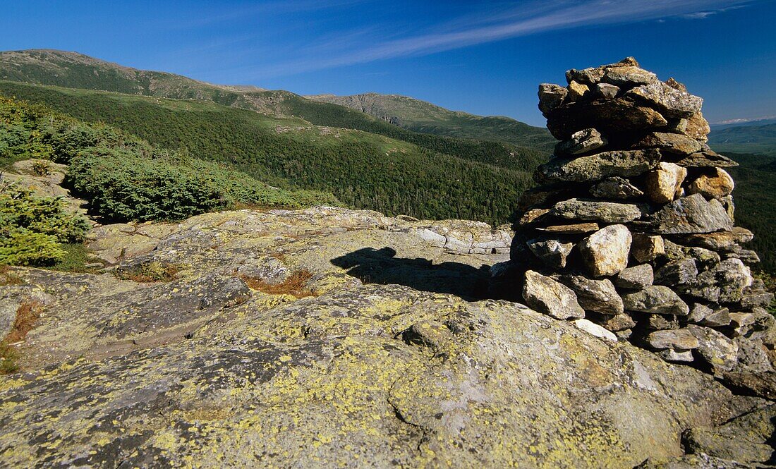 Hiking on Glen Boulder trail in the scenic landscape of the Alpine Zone Looking across the Gulf of Slides at Boott Spurleft and Huntington Ravinestraight ahead A rock cairn is in the foreground Located in the White Mountain National Forest of New Hamps