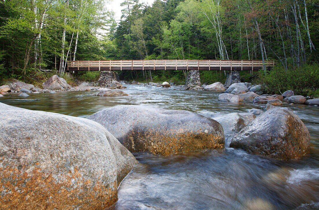 Foot bridge along the Lincoln Woods Trail which crosses Franconia Brook At the end of this bridge hikers enter into the Pemigewasset Wilderness Old abutments from Trestle 7 which was once part of the East Branch & Lincoln Logging Railroad are used to su