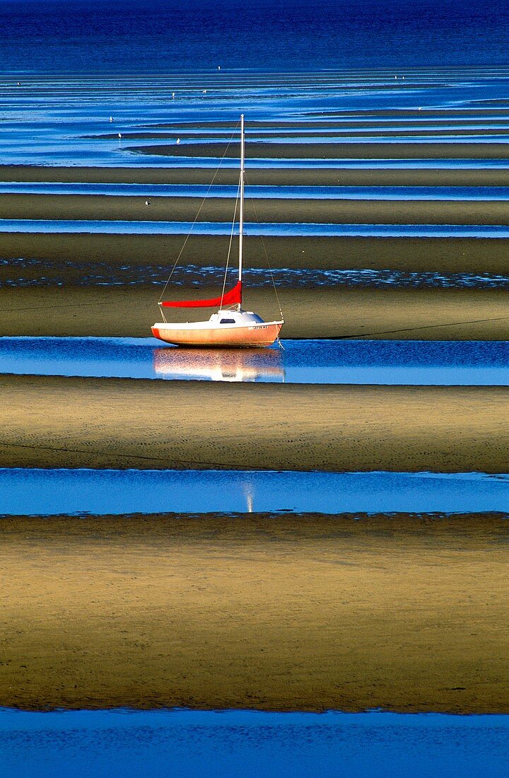 Sailboat anchored in tidal flats, Cape Cod Bay