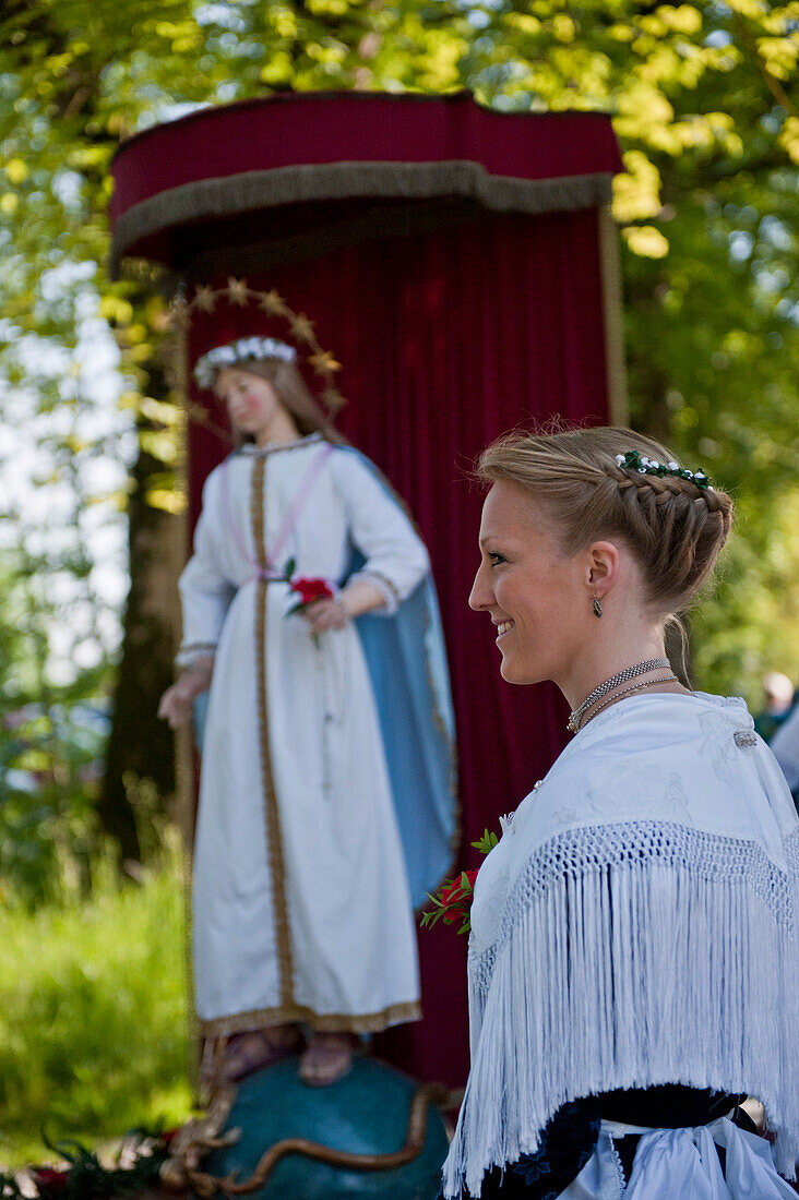 Woman in front of the statue of Maria, Corpus Christi procession, Bavaria, Germany, Corpus Christi procession, Benediktbeuern, Alpine foreland, Upper Bavaria, Bavaria, Germany