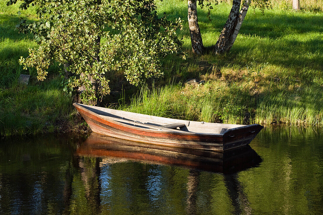 Rowing boat at the shore of a lake, Sweden, Scandinavia, Europe