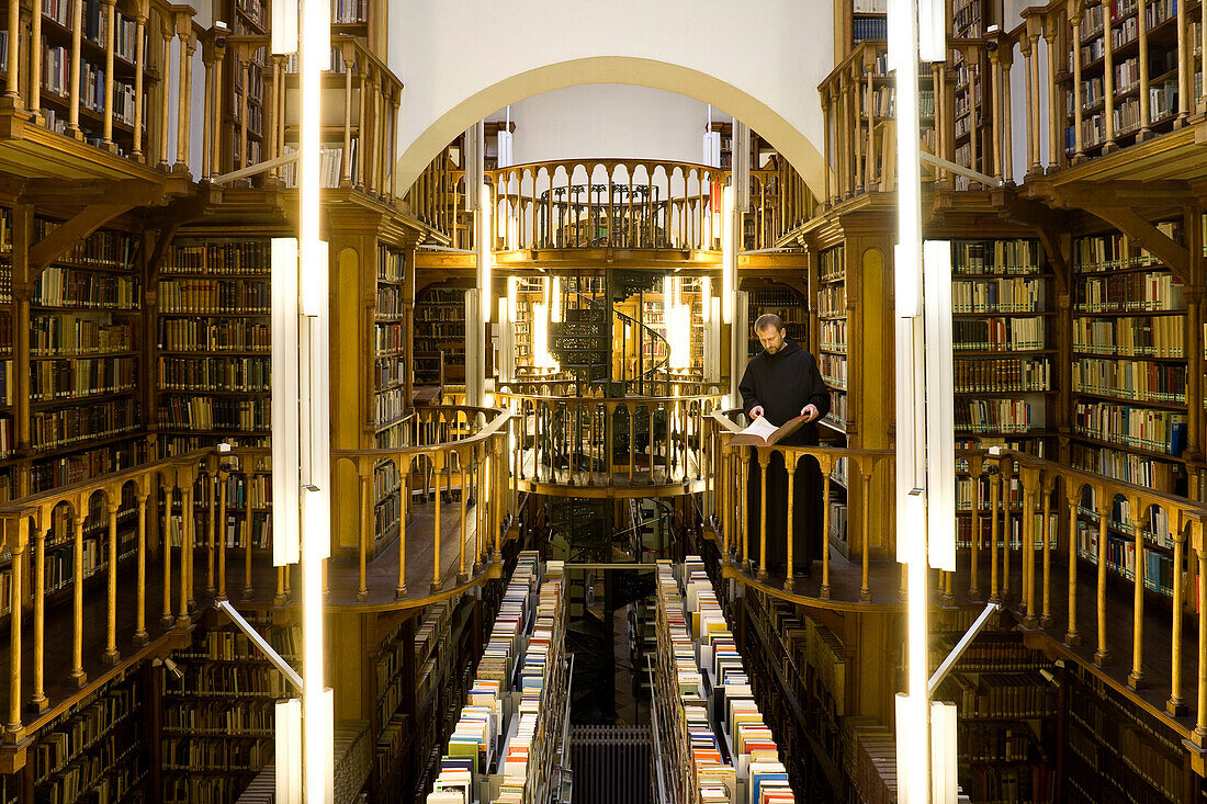 Monk at the library at Maria Laach abbey, Eifel, Rhineland-Palatinate, Germany, Europe