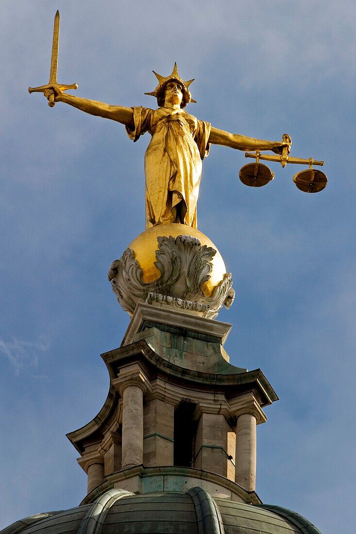 Scales of Justice statue on top of The Old Bailey central criminal court, London, UK Designed by E W Mountford