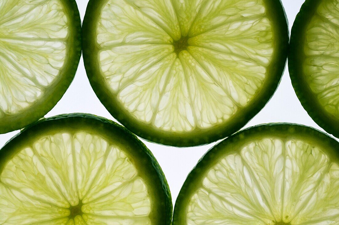 slices of lime, lit from behind Isolated against white